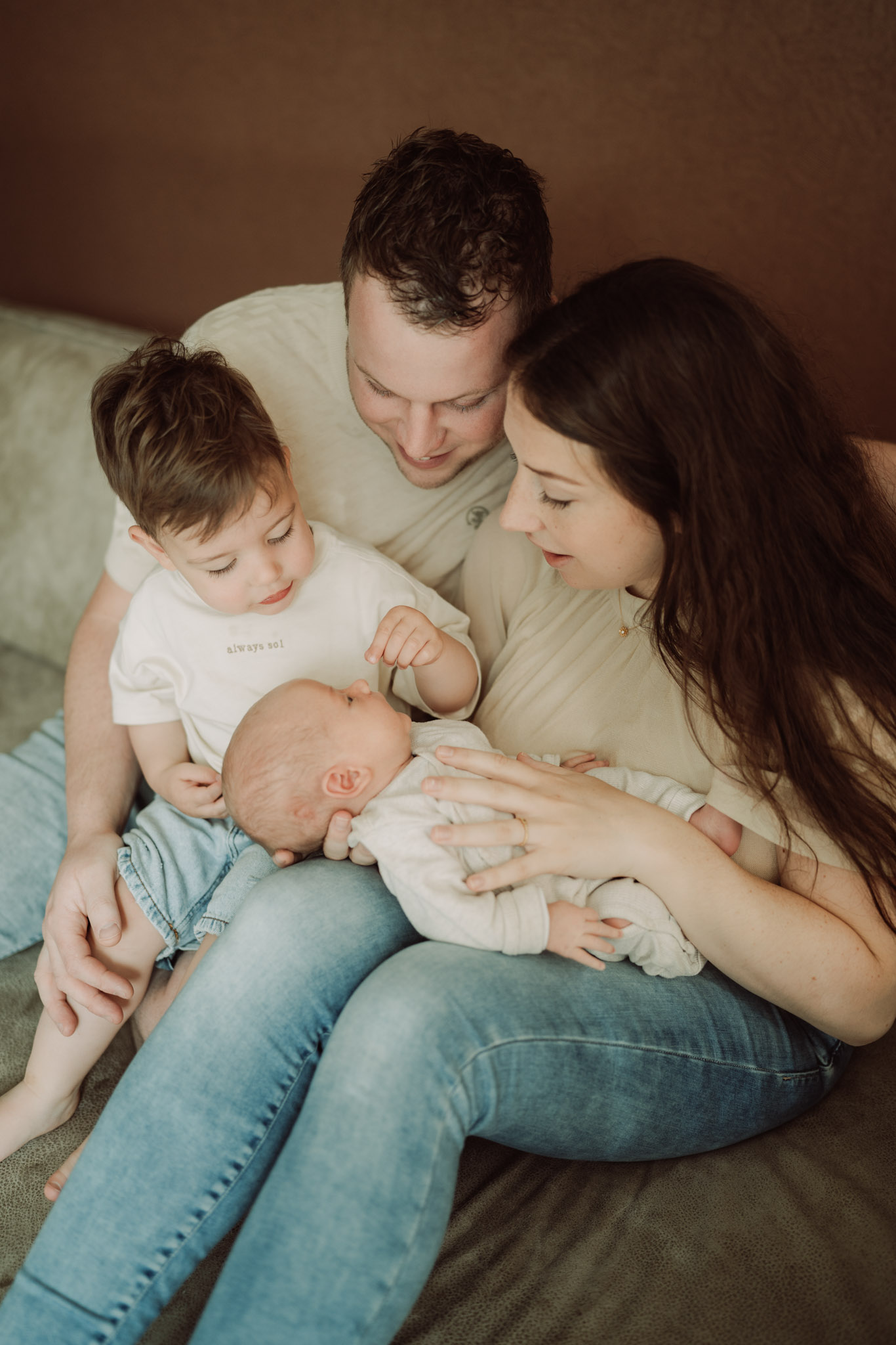 Kersvers gezin van vier – oudste broer kijkt vol verwondering naar zijn babybroertje